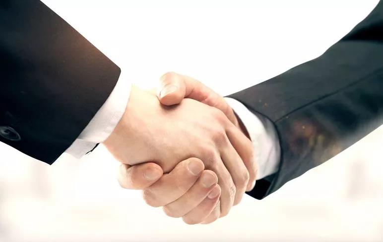 Asian male and female hands shaking hands in a professional school agreement